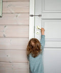 Child reaching for a brass doorknob with a Stainless Steel Heavy Duty Gate Hook and Eye Latch for Door Window Cabinet visible.