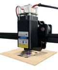 Front view of LASER TREE laser engraver module mounted on a rail, purple laser dot engraving wood
