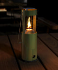Compact Real Candle Lantern for Camping and Emergency Lighting, 15 Hour Burn Time, portable green lantern on wooden table