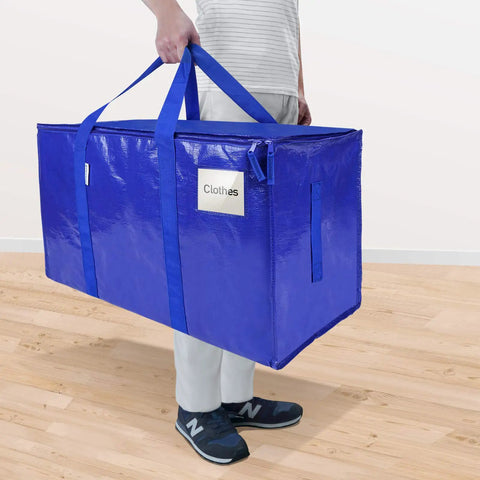 Person carrying blue Six Pack Extra Large Moving Bags Heavy Duty With Zippers And Carrying Handles Tough And Durable Storage Bags