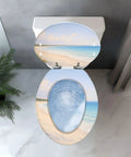 Elongated Toilet Seat Replacement for Bathroom Use with beach scene design and blue water swirl, top view.