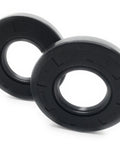 Close-up of two black rubber oil seals, 25 x 52 x 7 mm, double‑lip TC style rotary shaft seals.