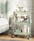 Three Tier Rolling Cart Storage Organizer With Metal Wheels Pegboard Hooks And Bins For Bathroom Kitchen Office Nursery And Craft Rooms placed beside bed, filled with books, toiletries, and decor.