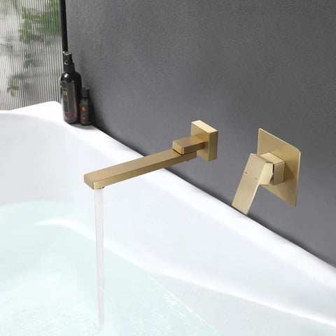 Gold wall mount tub filler with lever handle and waterfall spout over bathtub