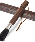 Front view of Takavu coffee grinder cleaning brush with black boar bristles, wooden handle and leather lanyard