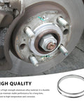 4 Pack Hub Centric Rings 67 To 73mm Wheel Center Bore Adapters Aluminum Alloy installed on a brake rotor for noise reduction.