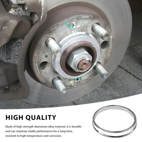 4 Pack Hub Centric Rings 67 To 73mm Wheel Center Bore Adapters Aluminum Alloy installed on a brake rotor for noise reduction.