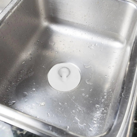 Close-up of 4pcs Rubber Bathtub Drain Stopper with Pull Ring fitted in a stainless steel sink, showcasing its waterproof seal.