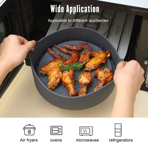 Person placing a Reusable Air Fryer Silicone Liners Set With 2 Liners And Split Strip For 5 Qt And Up in an appliance with chicken wings inside.