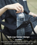 Ultra Lightweight Folding Camping Chair With Carry Bag For Beach And Lawn Totally Portable And Easy To Carry Nine Pound Weight Perfect For Camping Tailgates Picnics Beach Parties Outdoor Sports And Backyard Hangouts Black with side cup holder in use with water bottle.