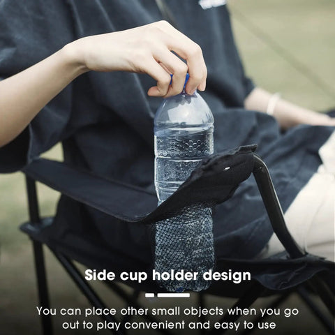 Person sitting on Four Pack Folding Camping Chairs Weigh Just Four Pounds, Ultra Portable With Carry Bag, showing cup holder with bottle