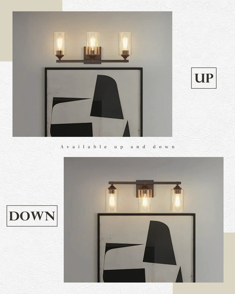 Three Light Vanity Lights With Dope Oil Rubbed Bronze Finish And Clear Glass Shades mounted up and down over artwork