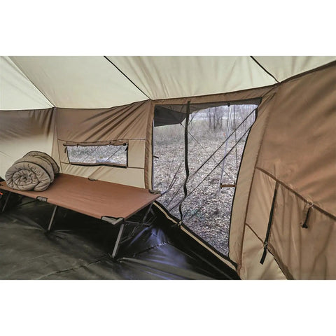 Interior view of Base Camp Tent For All Weather Adventures With Stove Jack Four Season Camping showing cot, window, and beige fabric.