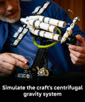 Person adjusting the Project Hail Mary Microscale Spacecraft Model Collectible Set For Adults, 11389 with gravity system feature.