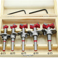 5-piece tungsten carbide hinge drill bit set in wooden case; sizes 15–35 mm with red tops.