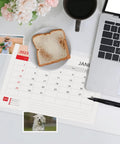 Clear Table Protector Mat 14 By 24 Inches, 1.5mm thick heavy duty desk cover showing a calendar, toast, and workspace setup