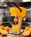 Heavy Duty Electric Citrus Juicer With Three-Blade Steel Cutter Head For High Yield And Quick Press Operation Detachable Design extracting juice from an orange in a kitchen.