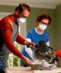 Two people wearing safety masks using a saw, simulating environment for Disposable Earplugs 80 Pair Self Adjusting Foam Noise Reduction