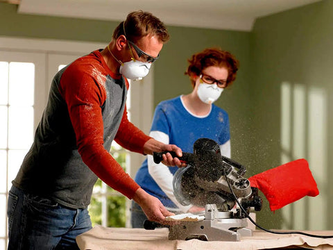 Two people wearing safety masks using a saw, simulating environment for Disposable Earplugs 80 Pair Self Adjusting Foam Noise Reduction