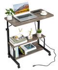 Hella Sturdy Adjustable Standing Desk On Smooth Lockable Wheels, Super Slick Rolling Laptop Station With Storage Shelves, Easy Setup Grey Oak Home Office Daily Driver with laptop and plants.