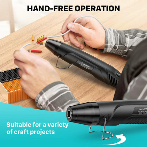 Compact Dual Temp Heat Gun With 350W 500F And 842F Settings in use for crafting, showing hands-free operation on a tabletop