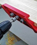 Adjustable Dowel Jig Kit With Precision Drill Bushing on wood, anodized aluminum, used for easy hole placement in cabinet assembly.