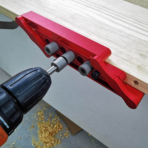 Adjustable Dowel Jig Kit With Precision Drill Bushing on wood, anodized aluminum, used for easy hole placement in cabinet assembly.