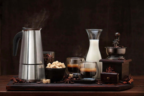 Stovetop Espresso Maker 9 Cup Moka Pot in Stainless Steel 450ml surrounded by coffee cups, milk, and sugar cubes on wooden tray.