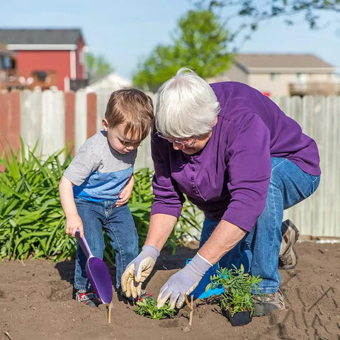 Elderly person and child using Three Pack Plastic Garden Shovels Set Hand Trowels For Planting Digging Transplanting outdoors