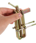 Heavy Duty Carbon Steel Two Jaw Gear Bearing Puller With Reinforced Grips being operated by hand for mechanic crews.