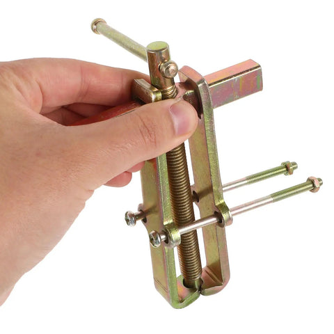 Heavy Duty Carbon Steel Two Jaw Gear Bearing Puller With Reinforced Grips being operated by hand for mechanic crews.