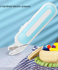 Cordless Electric Scissors For Fabric And Craft Cutting With Ergonomic Grip And Battery Powered Shears Built For Heavy Duty Sewing Tasks And Easy Cardboard Snipping With No Sweat Cuts on blue fabric background.