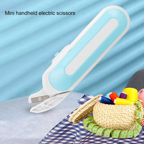 Cordless Electric Scissors For Fabric And Craft Cutting With Ergonomic Grip And Battery Powered Shears Built For Heavy Duty Sewing Tasks And Easy Cardboard Snipping With No Sweat Cuts on blue fabric background.