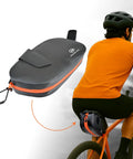 Waterproof Bike Seat Bag With TPU Welded Triangle Frame And YKK Zipper on cyclist's bike, black-orange design. Keeps items dry