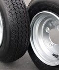 Heavy Duty 4 Lug Trailer Tire And Wheel Set 4.80-8 Size, Galvanized 6 Ply Load Range C shown in close-up, silver finish.