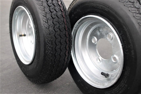 Heavy Duty 4 Lug Trailer Tire And Wheel Set 4.80-8 Size, Galvanized 6 Ply Load Range C shown in close-up, silver finish.