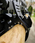 Close-up of Rugged Truck Shovel Holder with Quick Release Rubber Clamp mounted on a roof rack holding wooden handle tool.