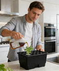 Man using Dope Compact Indoor Hydroponic System With Fifteen Pod Soilless Grow Kit in kitchen setting