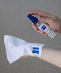 ZEISS 2oz lens cleaner spray bottle with blue nozzle and white microfiber cloth with ZEISS logo