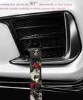 Sick JDM Koi Fish Racing Tow Strap mounted on car bumper, featuring heavy gauge nylon material and brass buckle.