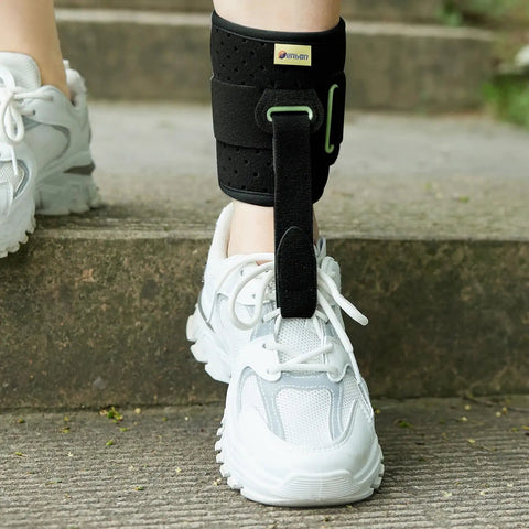 Person wearing Foot Drop Ankle Brace Orthosis With Cushioned Adjustable Wrap Compression For Easier Walking Gait Pain Relief