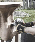 A craftsman using a Heavy Duty Mini Turbo Angle Grinder Kit With 50 Millimeter Tungsten Cutters for detailed wood sculpting.