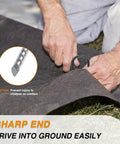 Hands using 8 Inch Rebar Garden Stakes Tough As Nails Ten Pack U Hook Metal Stakes Rust Proof Electrostatic Finish for ground cover.