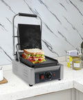 Heavy Duty Electric Panini Press Grill With 1800W Dual Heating Plates For Perfectly Grilled Steaks Hamburgers And Crispy Toasted Sandwiches on countertop with sandwich