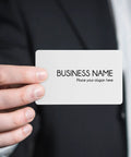 Hand holding a blank white PVC ID card from the Twenty Piece Bundle Of Slick Blank White Pvc Id Cards With Heavy Duty Waterproof Coating.