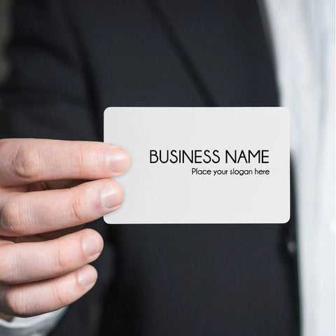 Hand holding a blank white PVC ID card from the Twenty Piece Bundle Of Slick Blank White Pvc Id Cards With Heavy Duty Waterproof Coating.