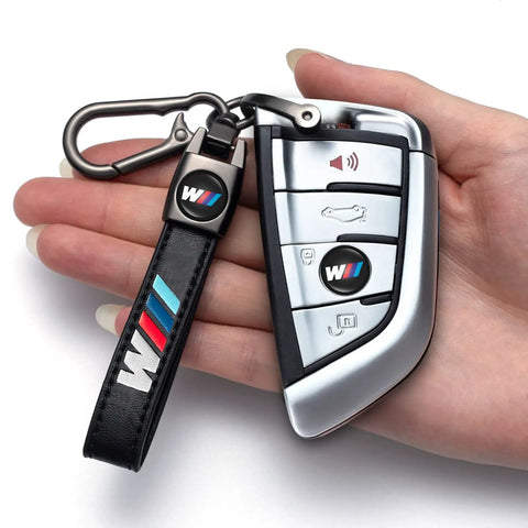 Hand holding BMW M Keyring And 4 Pack Dope Valve Stem Caps Car Keychain Set For M2 M4 M5 M6 M8 X1 X2 X3 X5 X6 M135i M240i