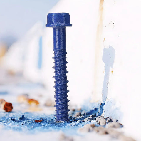 Heavy Duty Blue Hex Head Concrete Screw Anchors PTFE Coated Carbon Steel 1/4 In X 2-3/4 In 200 Pc Bulk Pack inserted into concrete.