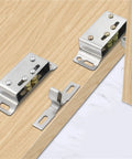 Slick Double Roller Cabinet Catch Set with stainless steel housing, copper tone shell, on wooden mounting base.
