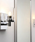 Super Cool Vintage Style One Light Wall Sconce With Clear Glass Shade And Metal Base In Chrome shown from side view in bathroom